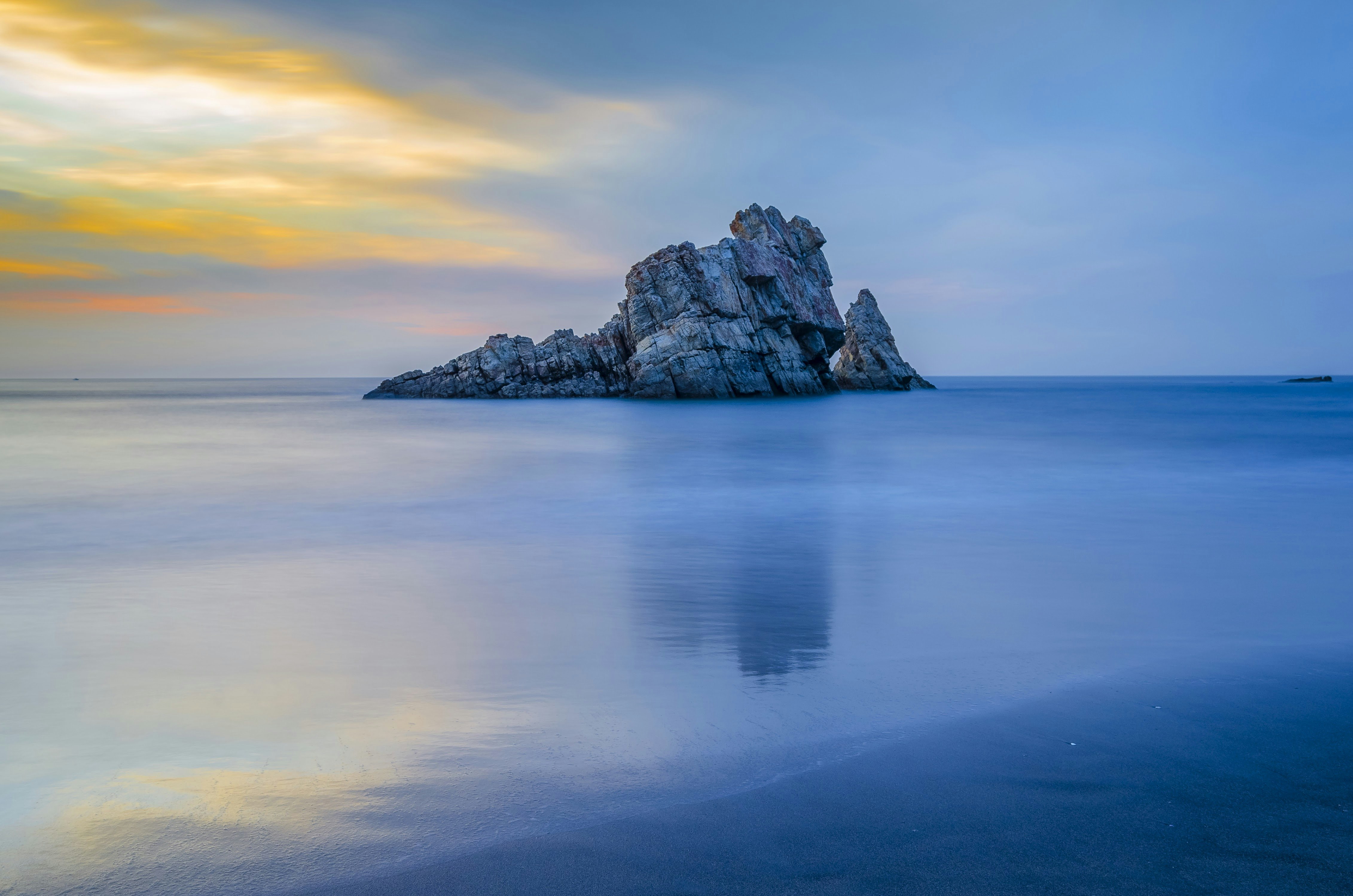 body of water across gray rock